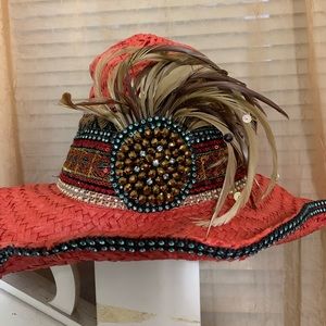 Red embellished hat with feathers